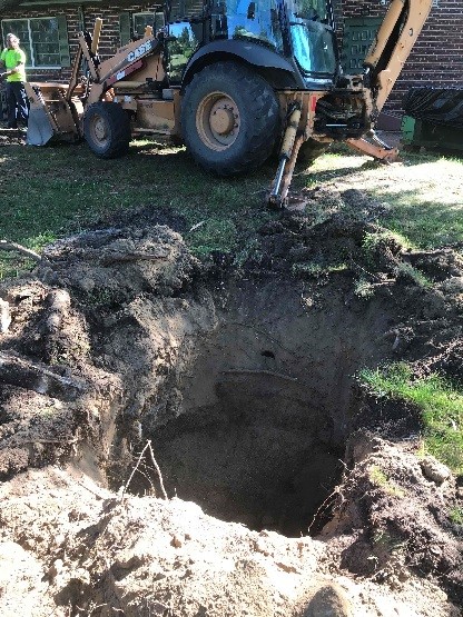 Digging a hole for new sanitary systems